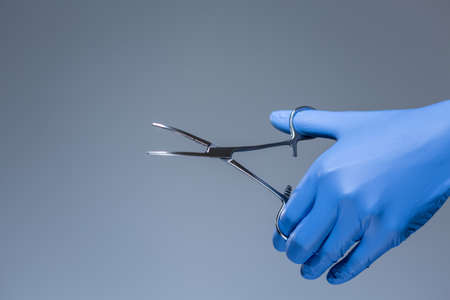 Close-up of scissors in the hand of doctor in hospitalの写真素材