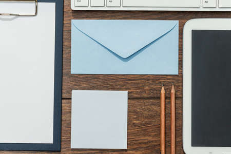 Clipboard, envelope and tablet with blank screenの写真素材