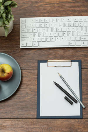 Close-up of business equipment on wooden deskの写真素材