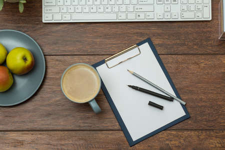 Cup of coffee on the desk in modern workplaceの写真素材