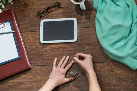 Image of woman painting nails in workplaceの写真素材