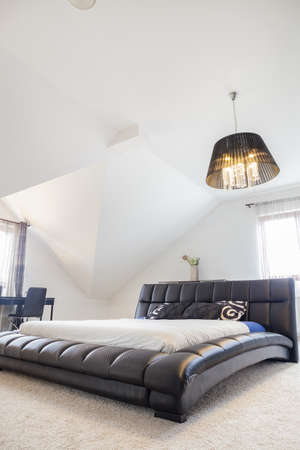 Comfortable king size bed in modern bedroomの写真素材