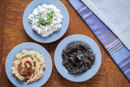 Tasty vegetarian sandwich spreads in blue bowls
