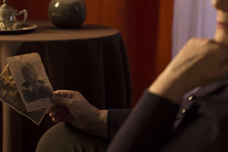 Close-up of grandmother looking at grandson pictureの写真素材