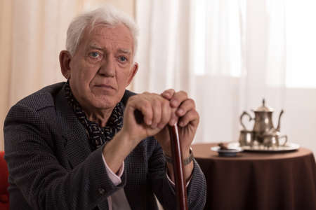 Portrait of sad old businessman suffering from loneliness