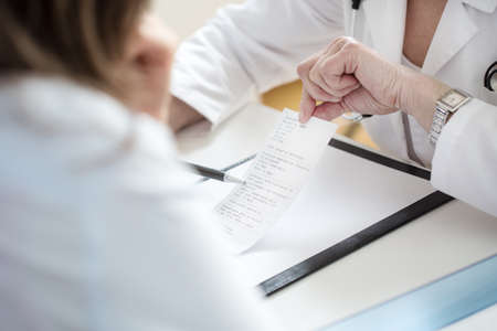 Horizontal view of female doctor explaining prescriptionの写真素材
