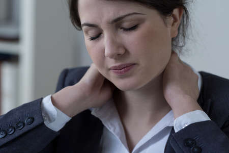 Female white-collar worker having neck pain