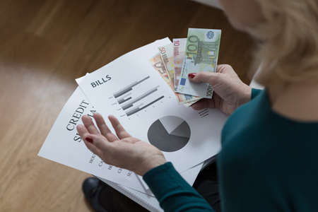 Woman paying off the loan analyzing her budget