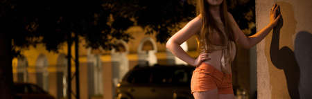 Young prostitute waiting for a client at night, panoramaの写真素材