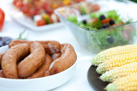 Sausages and corn prepared to do grillの写真素材