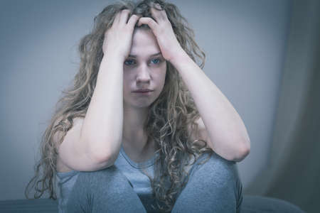 Depressed young woman trying to stop her tears