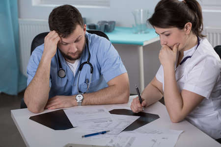 Worried doctors who did mistake in medical recordsの写真素材