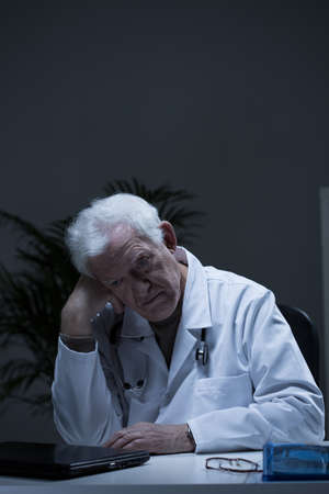Image of experienced doctor suffering for depressionの写真素材
