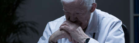 Depressed troubled doctor in his office - panorama