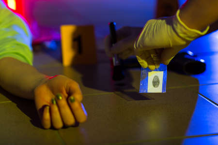 Close-up of crime scene investigator collecting evidenceの写真素材