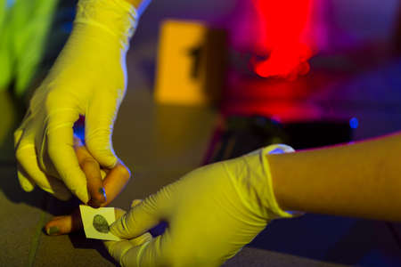 Close-up of forensic science technician taking fingerprintの写真素材