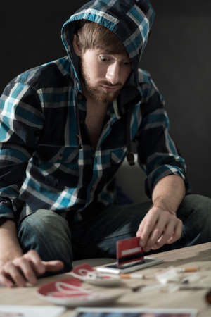 Addicted man preparing a line of cocaineの写真素材