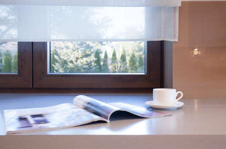 Break at home with cup of coffee and newspaperの写真素材