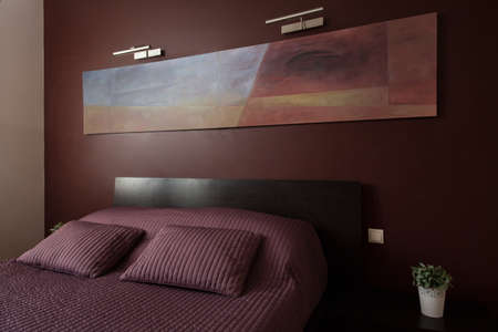 Luxury cozy bedroom with modern art on wallの写真素材