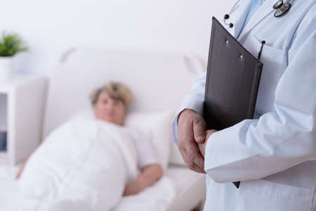 Doctor and senior patient in hospital roomの写真素材