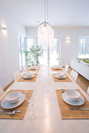Photo of elegant table setting on white wooden tableの写真素材