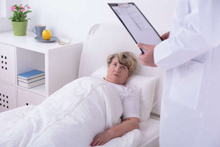 Ill elder woman lying in private clinicの写真素材