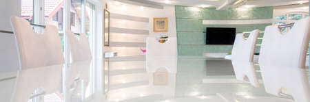 Panoramic view of white table inside expensive houseの写真素材