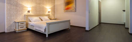 Stylish and elegant bedroom in hotel room, panoramaの写真素材