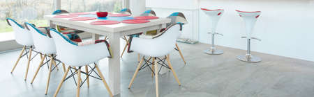 Modern dining table in interior with color elementsの写真素材