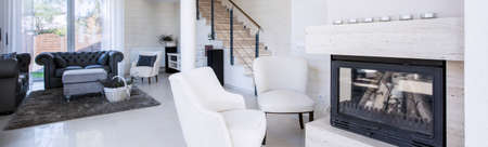 Interior of luxury living room with fireplace, panoramaの写真素材