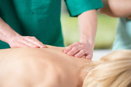 Photo of pleasant back massage in masseur's officeの写真素材