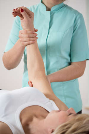 Patient lying on the couch during arm's rehabilitationの写真素材