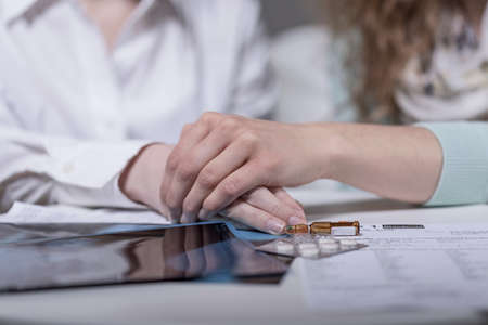 Close-up of woman comforting seriously ill friendの写真素材