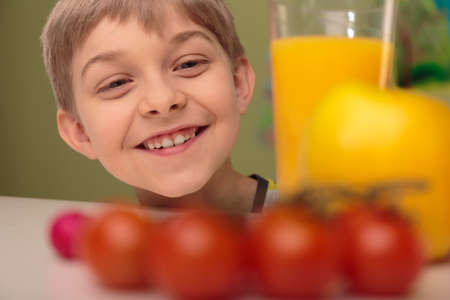 Portrait of smiling child with fresh healthy foodの写真素材