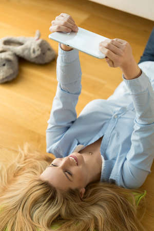 Pretty woman resting on the floor, verticalの写真素材