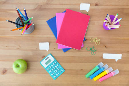 Colorful school supplies on the wooden desk