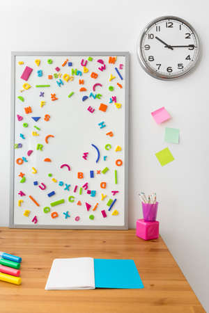 Wooden desk and magnetic board in kid's roomの写真素材