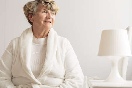 Senior woman wearing dressing gown at homeの写真素材