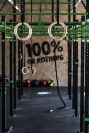 Photo of crossfit zone with gymnastic circles on gymの写真素材