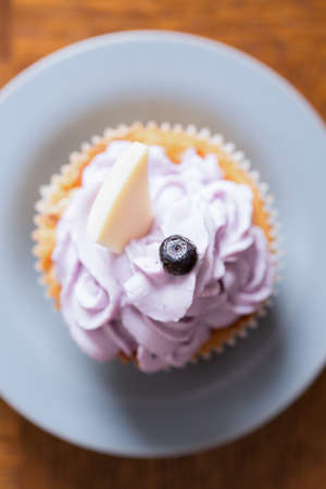 Tasty cupcake with mascaropne and blueberry and chocolate on topの写真素材