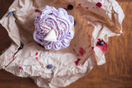 Unpacked blueberry muffin with white chocolate on topの写真素材