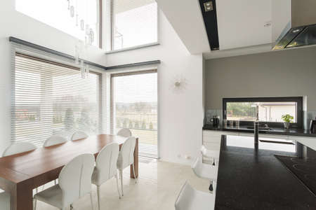 Modern dining room and kitchen in big expensive residence