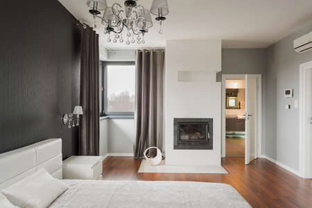 Old fashioned stylish bedroom with fireplaceの写真素材