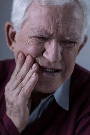 Old man with horrible toothacheの写真素材