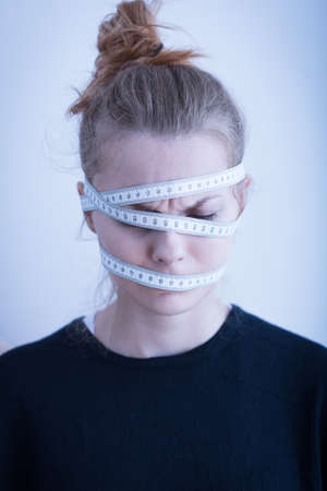 Measuring tape wrapped around the female headの写真素材