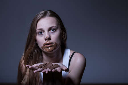Girl with eating disorder during bulimic attackの写真素材