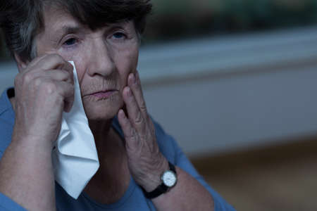 Old devastated women in mourning is cryingの写真素材