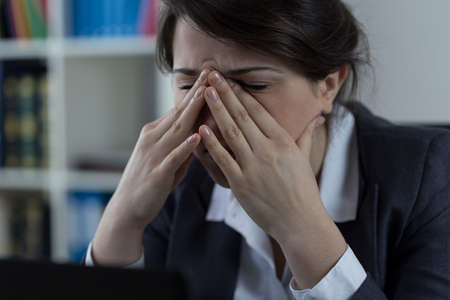 Business worker at office with sinus pain