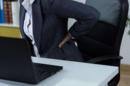 Office worker with backache after long work in front of computerの写真素材