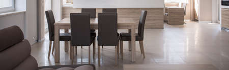 Wooden family dining table with leather chairs